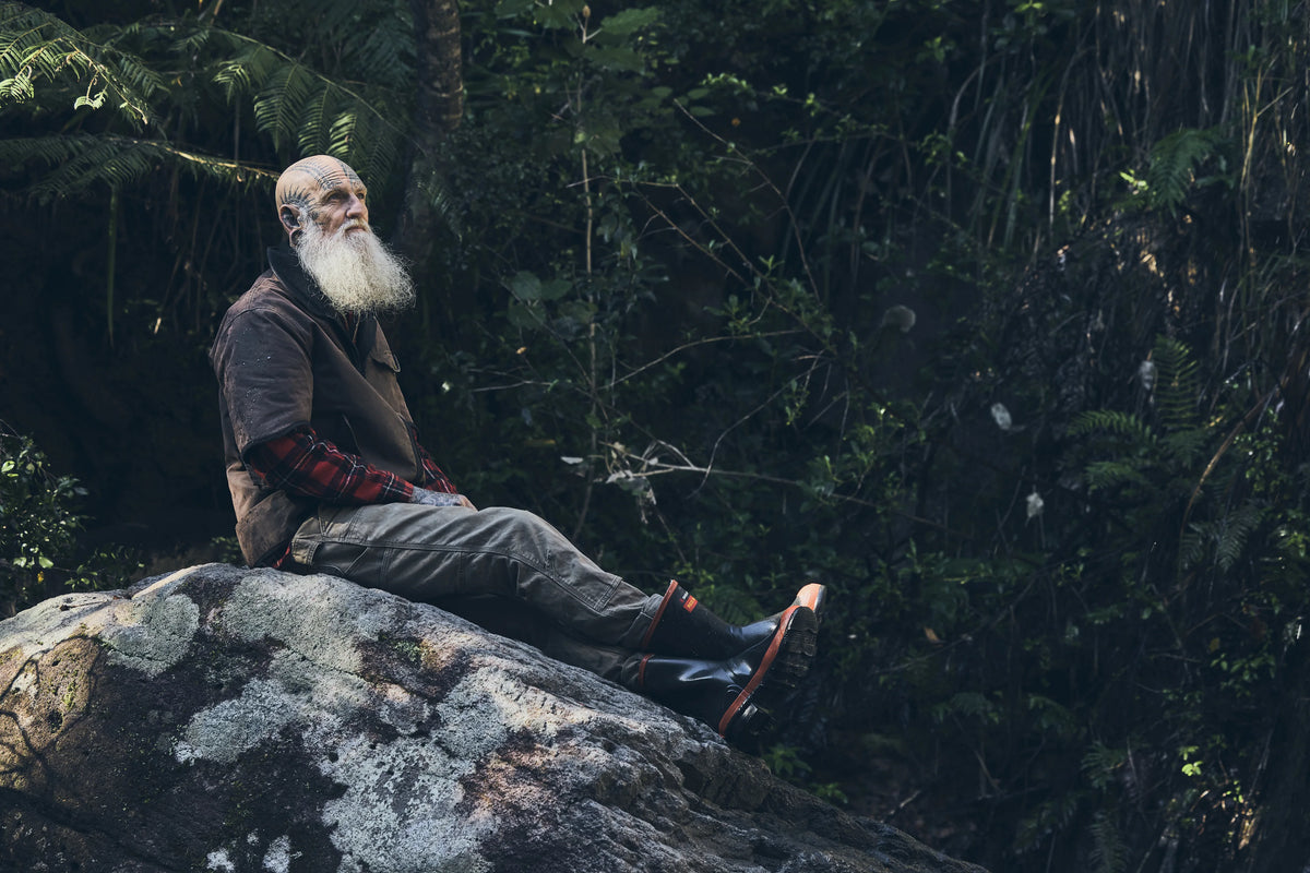 Tattoo artist Brent McCown, GRAPHICA Global Top 100, seated in the rainforest