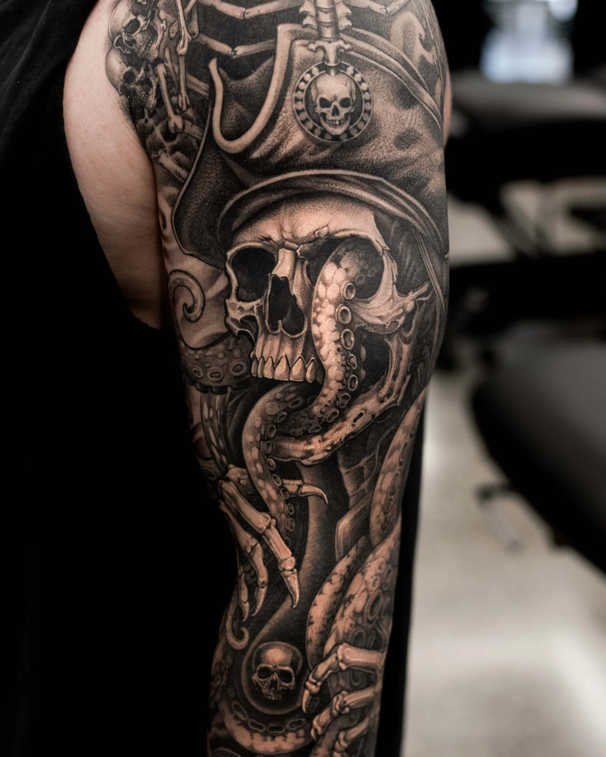 Black and grey skull sleeve by Coen Mitchell, GRAPHICA Global Top 100 tattoo artist