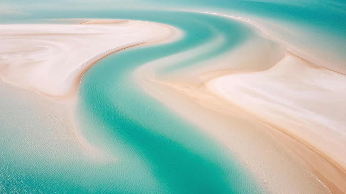 White silica sand swirling through turquoise water in the Whitsundays, Australia