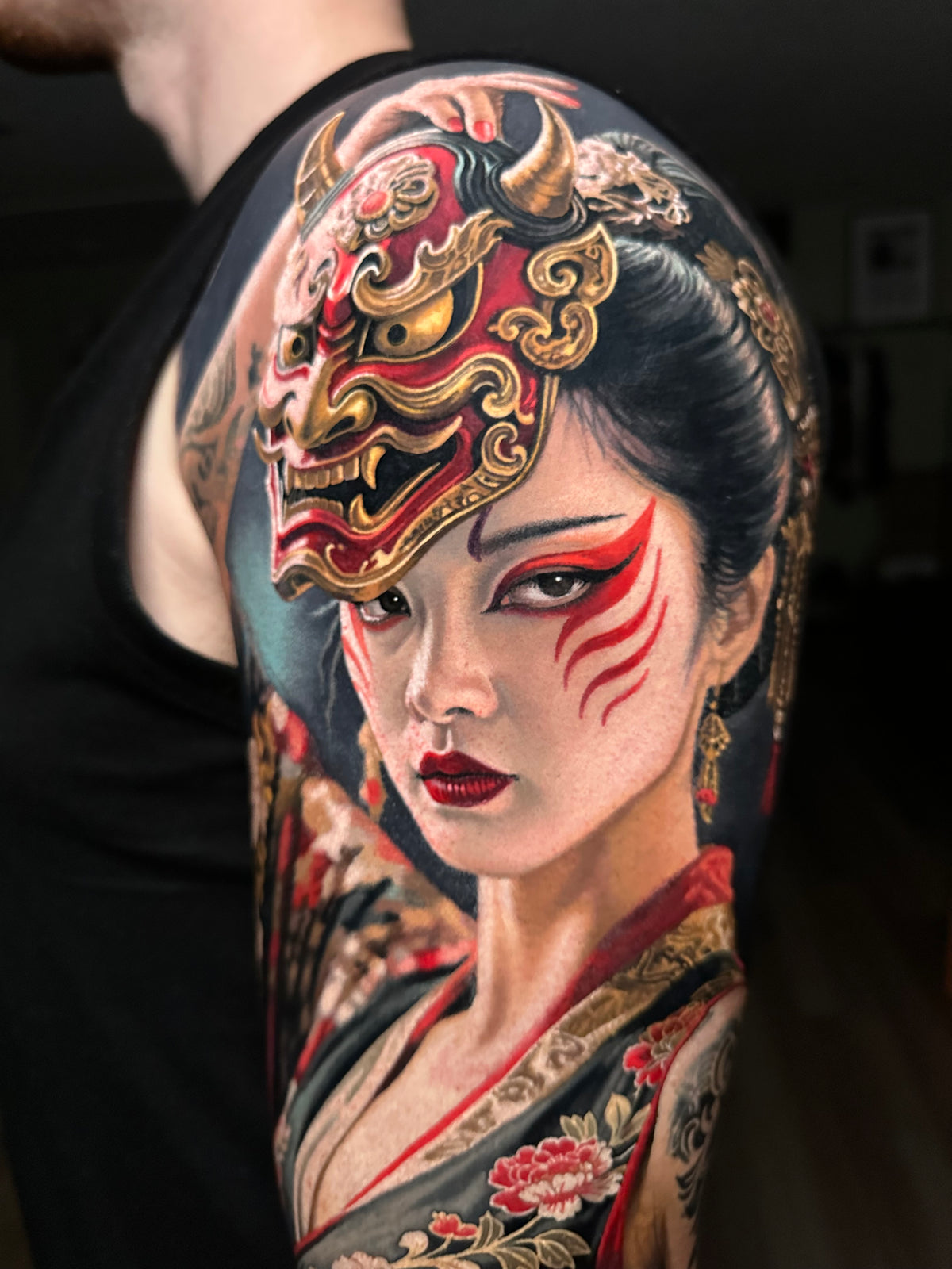 Realism tattoo of a geisha with an oni mask by Steve Butcher, Black Ivy Global Top 10